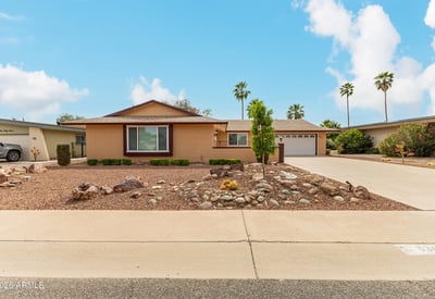 Wide driveway and open front yard offering plenty of parking and easy access. This Sun City home combines functionality with attractive desert landscaping.