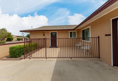 Secure front patio with gated entry, ideal for outdoor seating. This Sun City home features updated finishes and inviting outdoor spaces.