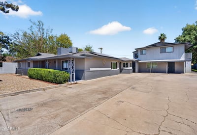 Oversized driveway offering easy access to multiple units, enhancing convenience and rental appeal in this updated Phoenix income property.