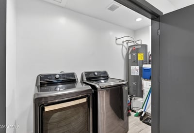 Convenient interior laundry space with appliances and storage, enhancing everyday functionality.