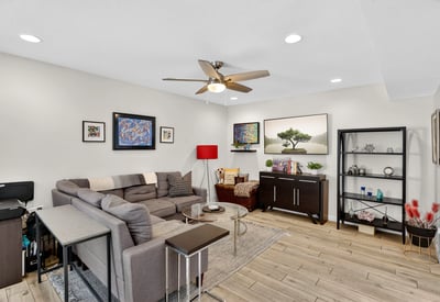 Spacious Scottsdale living room with modern finishes, recessed lighting, and open flow into the dining area perfect for relaxing or entertaining.