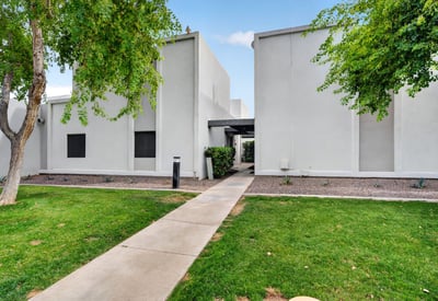 Attractive Scottsdale exterior with green lawn, mature trees, and clean design offering great curb appeal and community atmosphere.
