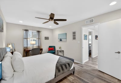 Comfortable Scottsdale bedroom with ceiling fan, updated flooring, and generous space for relaxing and unwinding.