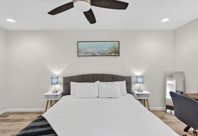 Open and inviting Scottsdale primary bedroom with updated finishes, generous space, and a calming neutral palette.