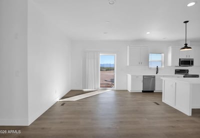 Open dining space positioned beside the kitchen and backyard access, offering abundant natural light and easy indoor-outdoor flow. Modern finishes and an open layout create an ideal setting for gatherings and family meals.