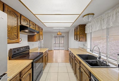 Offering abundant cabinetry and practical workspace, this kitchen provides functionality and convenience. Easy access to adjacent living spaces makes it ideal for everyday meals and gatherings.