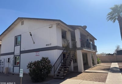 Inviting exterior perspective showcasing the property's well-kept grounds, designated parking, and mature landscaping. Residents enjoy a convenient Glendale location near dining, retail, and recreational opportunities.