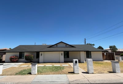 Beautiful front elevation highlighted by a covered entry, flowering shrubs, and clean desert-friendly landscaping. This move-in-ready home offers timeless style and convenience.