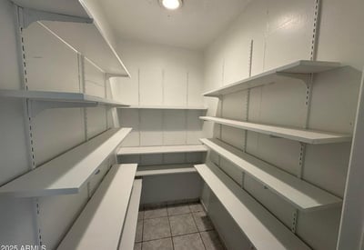 Oversized walk-in pantry with wall-to-wall shelving and dedicated storage areas for kitchen essentials. This desirable feature adds convenience, organization, and valuable storage capacity for everyday living.