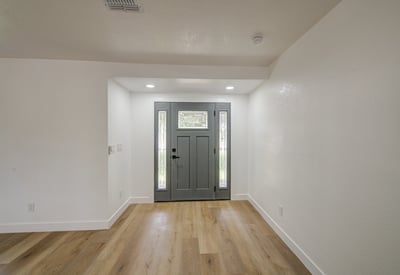 Modern finishes, new flooring, updated trim, and abundant natural light create an elegant entry that welcomes family and guests into this beautifully renovated home.