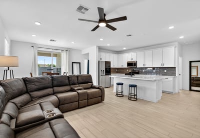 Designed for everyday comfort, the spacious great room features durable wood-look flooring, recessed lighting, ceiling fan, and an open connection to the kitchen for easy entertaining.