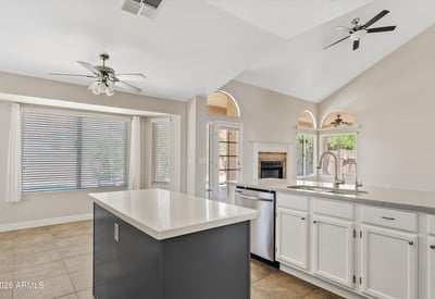 The updated kitchen features a large center island, stainless steel appliances, newer finishes, and an open layout overlooking the family room with backyard access. A perfect design for entertaining and everyday living.