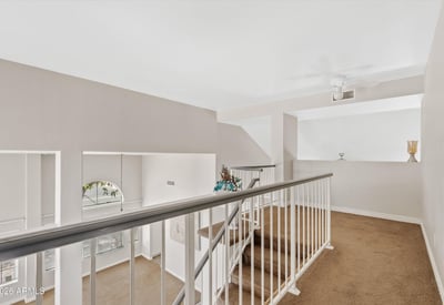 The open loft overlooks the main living area and offers endless possibilities as a family room, media space, playroom, or home office. A valuable bonus feature of this Chandler home.