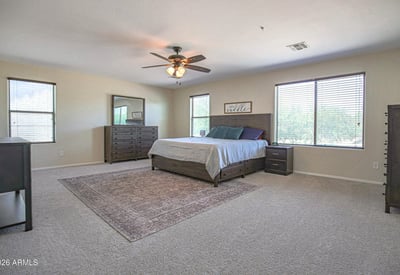 Large primary suite with abundant natural light, generous floor space, and room for additional seating or a private retreat. Designed for comfort and relaxation.