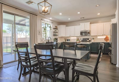 Spacious dining room with backyard views, large sliding glass doors, and an open connection to the updated kitchen, creating a bright and inviting entertaining space.
