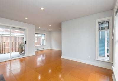 Spacious open-concept living area with natural light and access to a private outdoor balcony.