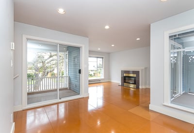 Bright and airy living space featuring a cozy fireplace and direct access to outdoor views.