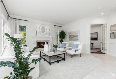 living space features a cozy fireplace and large windows, perfect for relaxation and gatherings.