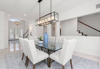 Bright and airy dining area, featuring a modern glass table and plush seating, perfect for gatherings.