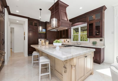 Discover a stunning kitchen featuring rich cabinetry, a spacious island, and modern appliances, perfect for entertaining.