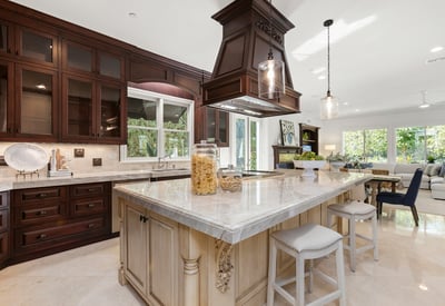 Spacious kitchen featuring a central island, modern appliances, and abundant natural light from large windows.