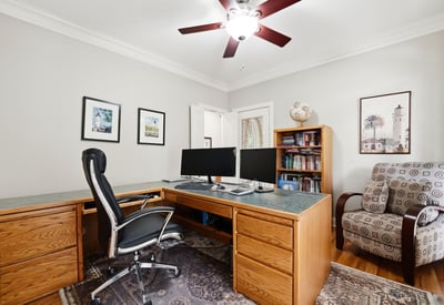 Spacious home office featuring dual workstations, ample storage, and natural light for productive days.