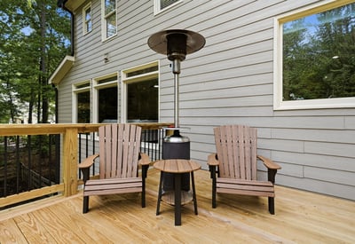 Cozy outdoor space featuring comfortable seating and a patio heater, perfect for year-round relaxation.