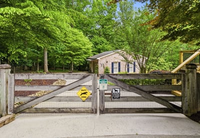 Nestled amid lush greenery, this property features a welcoming entrance and ample outdoor space for relaxation.