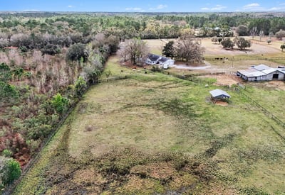 An aerial photo of the pasture and the steel Morton building which can be enclosed to become that shop or RV storage you've dreamed of!