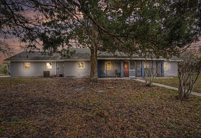 This 3 BR Ranch-style home features an abundance of natural wood and stone accents. Blending country charm with modern convenience, located close to beaches and shopping, this serene 5-acre setting encourages relaxation and creativity.