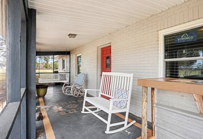 View of the Front Porch, which is fully screened to enjoy an evening drink all while taking in that immaculate Florida sunset!