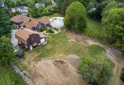 Spacious property featuring a large pool area, surrounded by lush greenery and ample outdoor space.