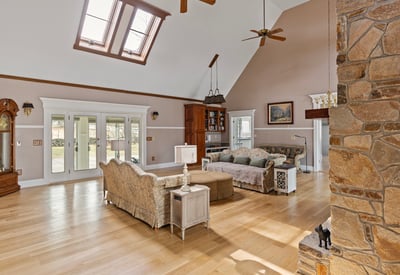 Spacious living area with large windows and unique architectural features, perfect for entertaining or relaxing.
