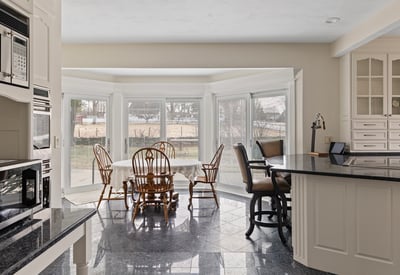 Spacious kitchen features large bay windows, ideal for natural light and relaxed dining experiences.