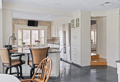 Bright, spacious kitchen features modern appliances, ample counter space, and a cozy dining area for gatherings.