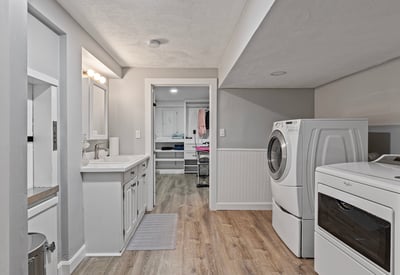 Bright and functional laundry room featuring modern appliances and ample storage space for organization.