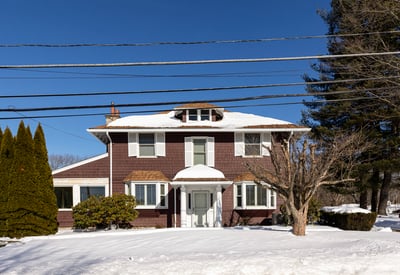 Spacious two-story home with ample outdoor space, located in a peaceful, snow-covered neighborhood.