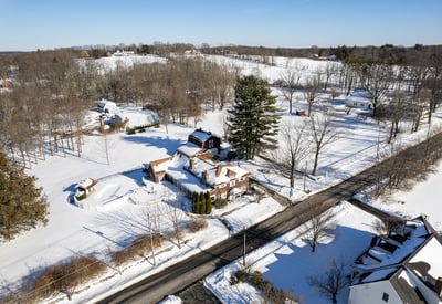 Spacious homes on expansive snowy lots, surrounded by trees and tranquil countryside views, perfect for peaceful living.