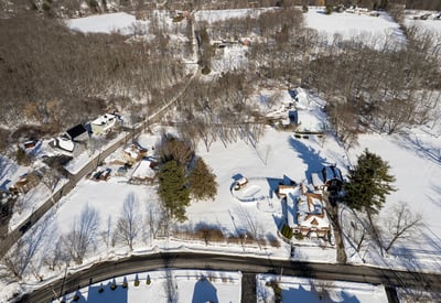 Expansive winter landscape featuring spacious lots and scenic views, perfect for your dream home development.