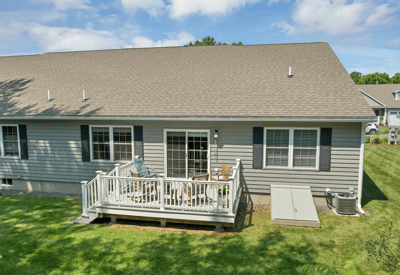 Cozy home features a spacious deck, perfect for outdoor gatherings and enjoying the scenic backyard.