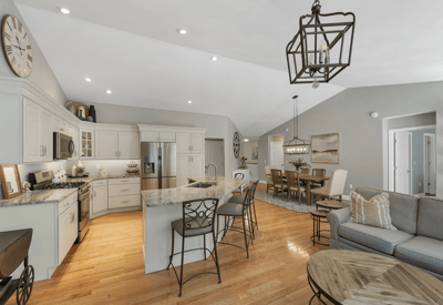 Bright open-concept living space featuring a modern kitchen, spacious dining area, and comfortable seating arrangements.