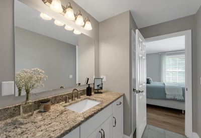 Contemporary bathroom featuring modern fixtures and a clean, open layout, seamlessly connecting to the adjacent bedroom.