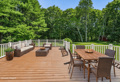Spacious outdoor deck perfect for entertaining, surrounded by lush greenery and a tranquil atmosphere.