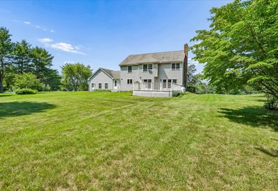 Spacious home surrounded by lush greenery, offering a peaceful retreat with ample outdoor space.