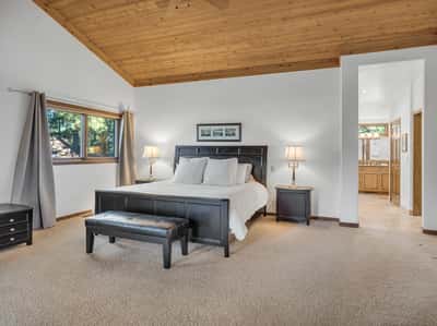 Beautiful primary suite with vaulted wood ceilings, expansive layout, and peaceful golf course surroundings in Forest Highlands. This spacious retreat offers comfort, privacy, and luxury mountain living in Flagstaff.