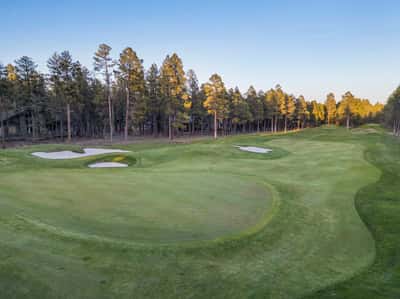 Scenic golf course views featuring manicured greens, sand bunkers, and towering pine trees. This premium Forest Highlands setting provides a peaceful and picturesque backdrop for luxury mountain living.