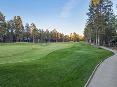 Beautiful views of rolling fairways bordered by mature pine trees and landscaped greens. This scenic golf course environment enhances the peaceful atmosphere surrounding the property.