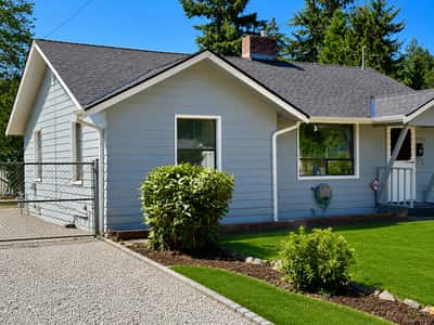 Features RV parking alongside of house, complete with electricity and a clean-out.