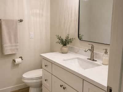 Main bathroom boasts a sleek vanity and contemporary fixtures.
