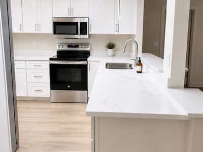 Quartz countertops, stainless steel appliances, and abundant natural light.